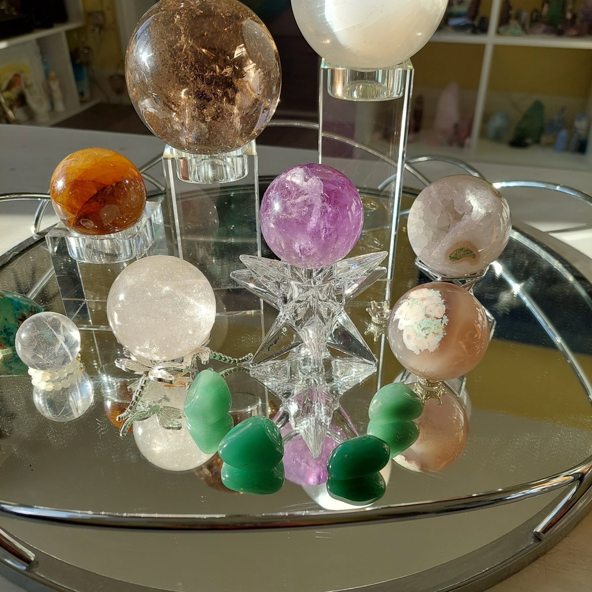 Polished crystal spheres and stones on a display stand