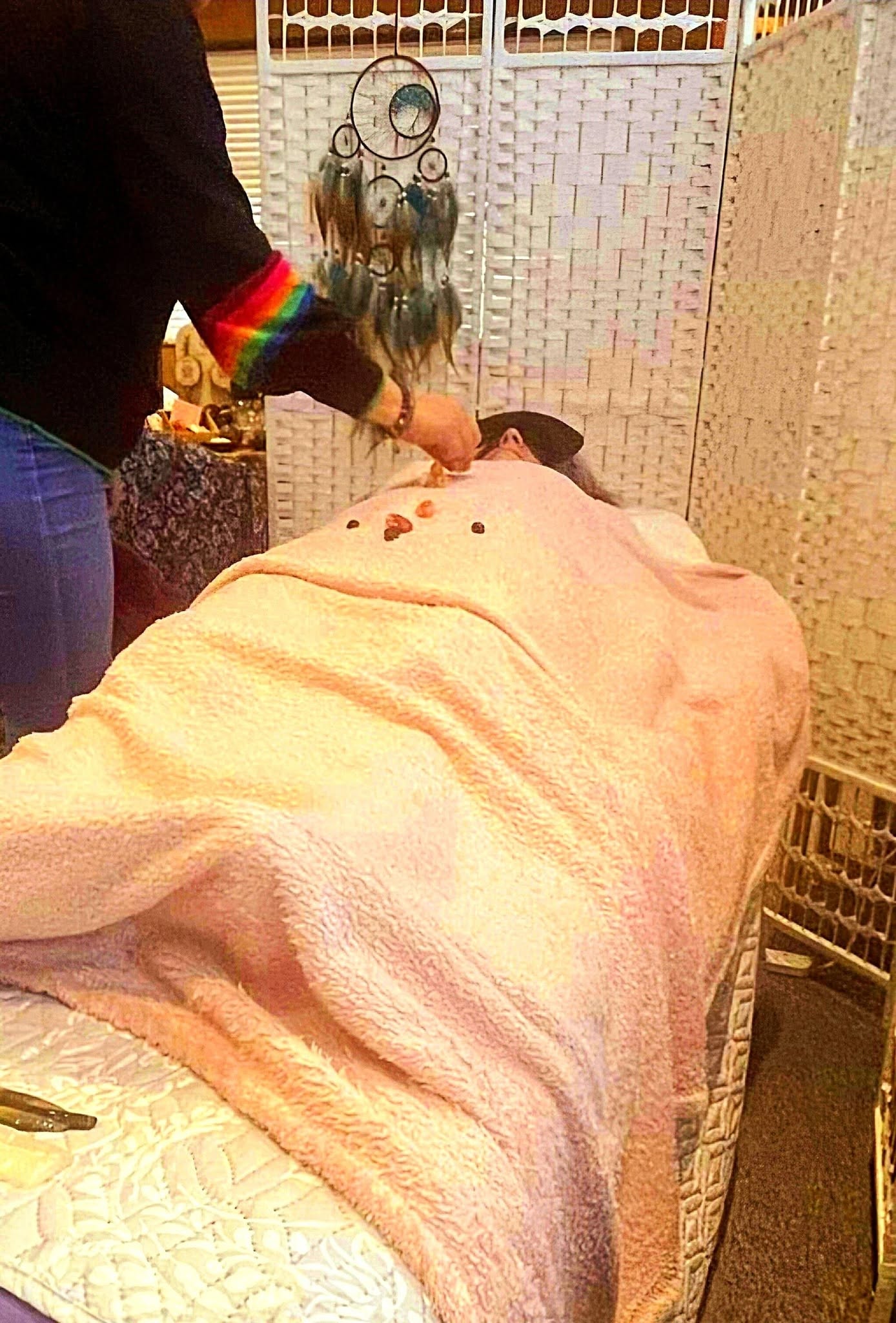 A crystal healing therapy session with a client relaxing
