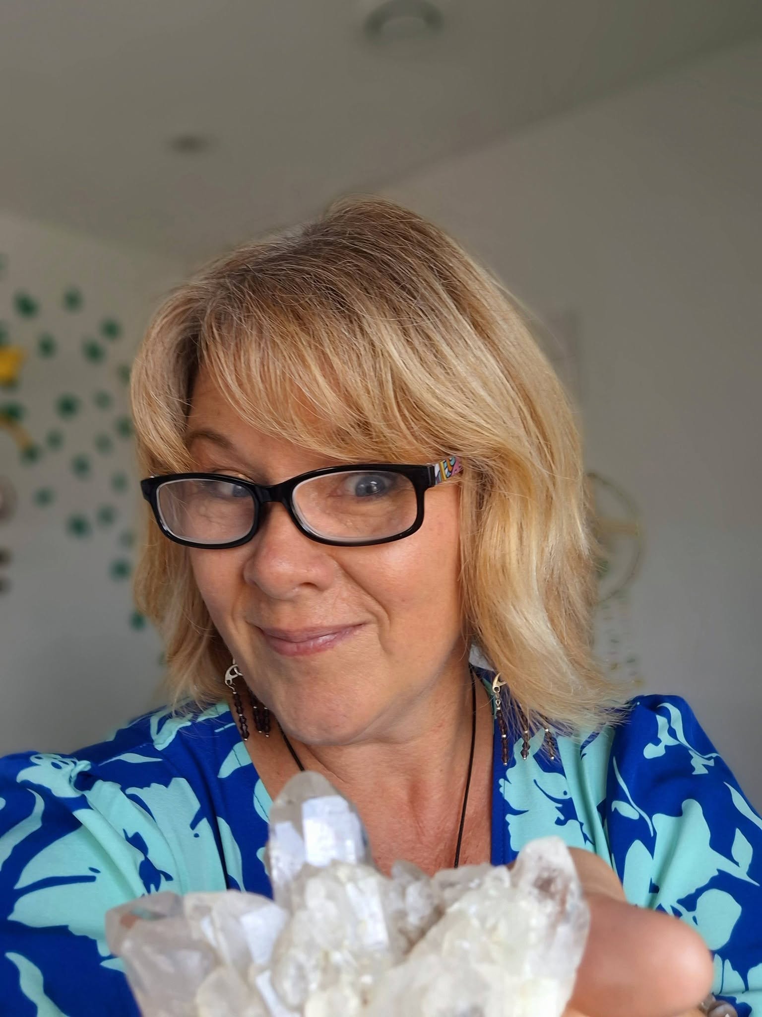 Bobbie, crystal practitioner, wearing a patterned blue shirt