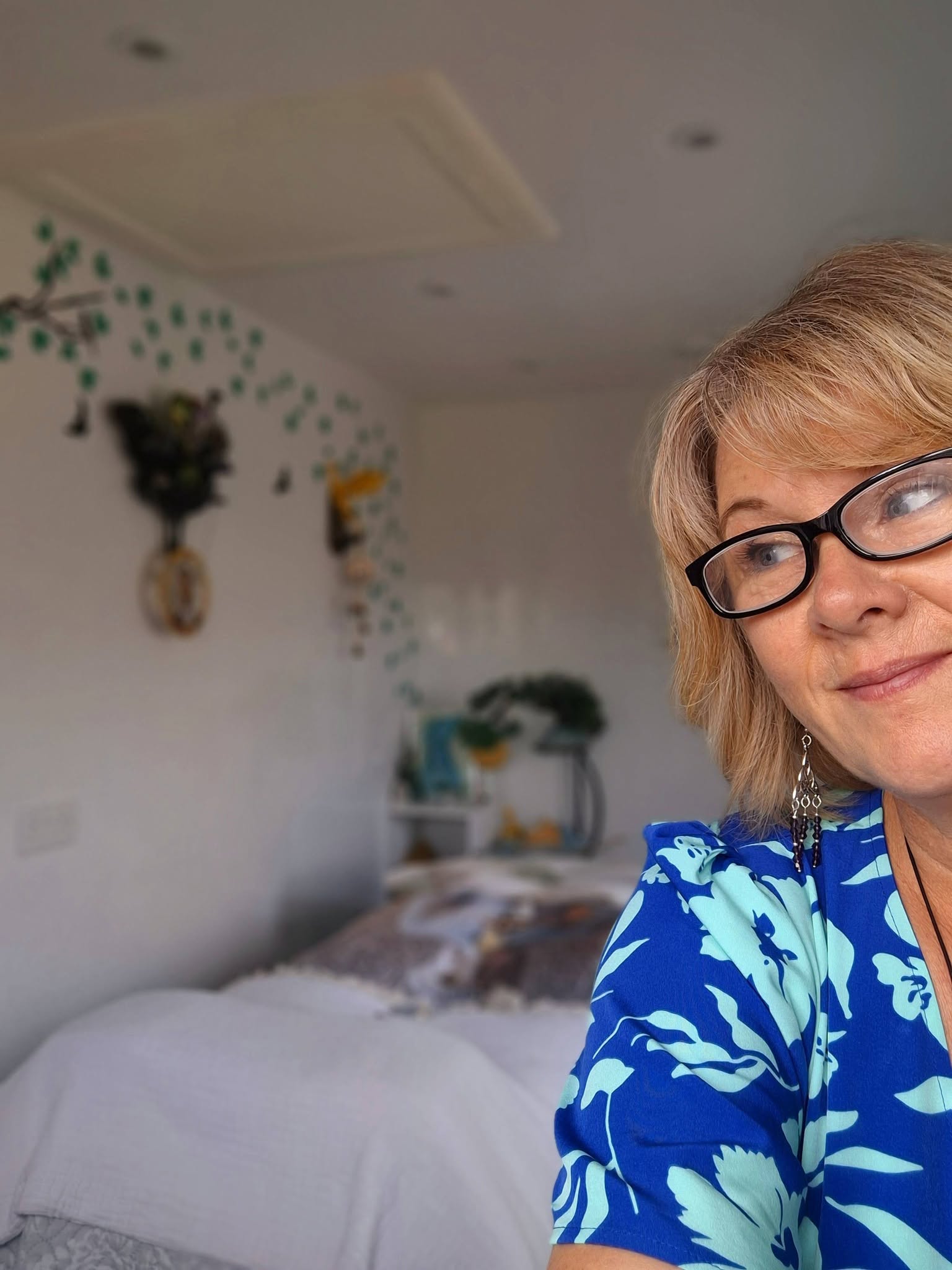 Bobbie, crystal practitioner, smiling indoors